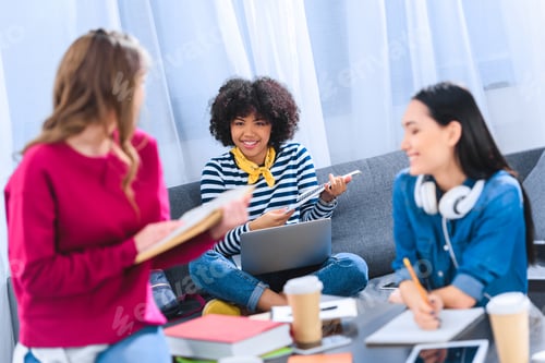 Preview: multicultural group of young students studying together