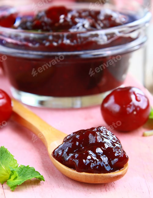Preview: cherry jam in a jar and fresh berries on the table