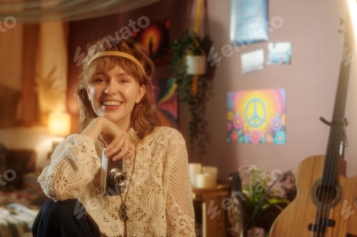 Preview: Smiling Woman Holding Camera in Cozy Artistic Room