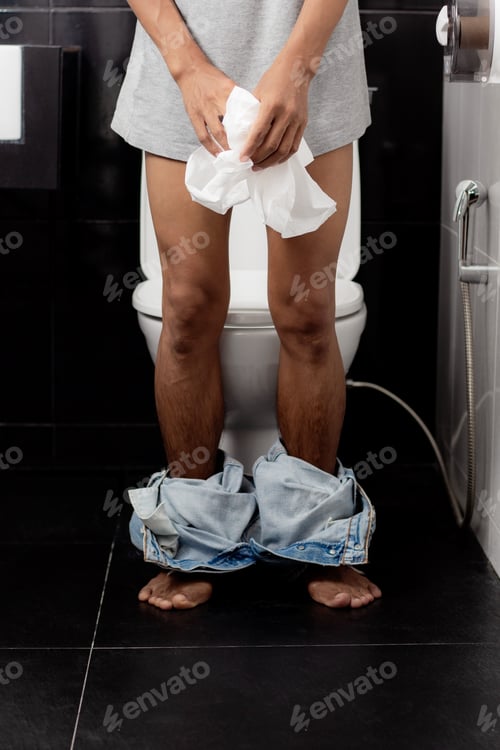 Preview: Men standing in toilet.
