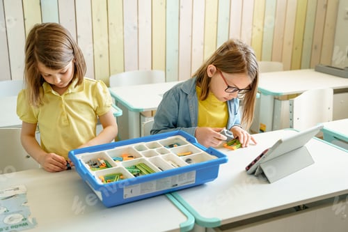 Preview: Programming work for robotics in elementary school. Children girls students assembly, launch, coding