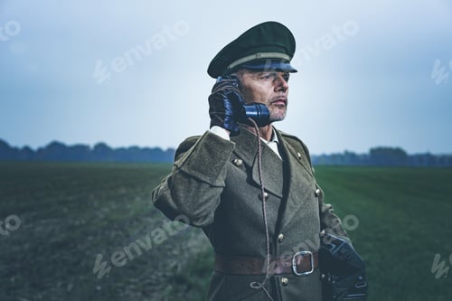 Preview: Vintage 1940S Military Officer Calling With Field Phone While Standing On Farmland.