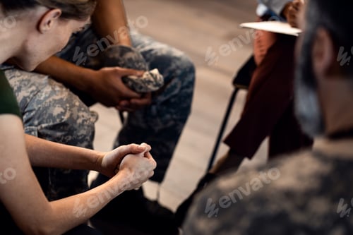 Preview: Close up of female veterans hans during PTSD support group.