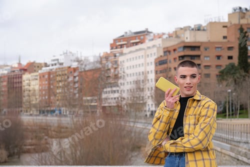 Preview: Young non binary person recording an audio on a smartphone. Make up androgynous person.