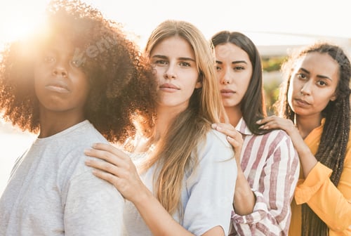 Preview: Four Smiling Women Posing Together in Bright Sunlight