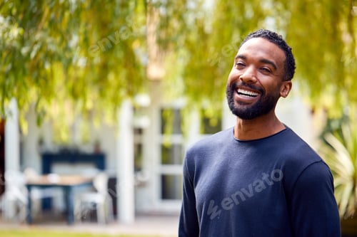 Preview: Portrait Of Relaxed Smiling Man Standing In Garden At Home After Retirement