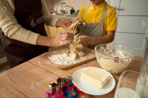Preview: Old female preparing dough for baking with grandson
