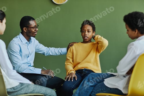 Preview: Dissatisfied schoolboy touching back of head while describing his problem
