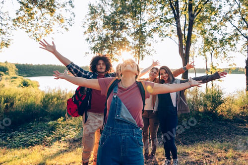 Preview: feeling freedom outdoor in nature - happy people open arms enjoy adventure on holiday