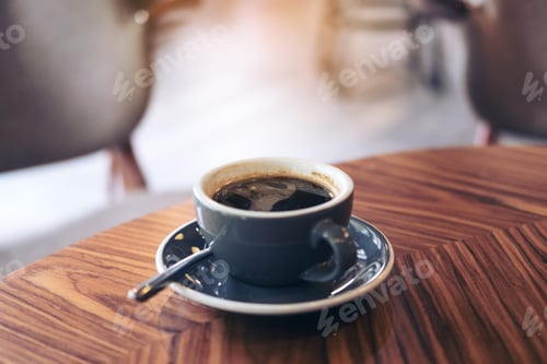 Preview: Closeup image of hot Americano coffee cup on vintage wooden table in cafe