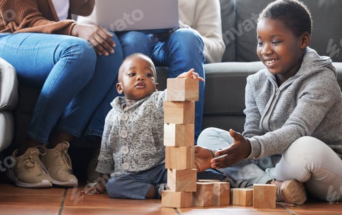 Preview: Shot of a sister helping her baby brother build blocks in the lounge at home