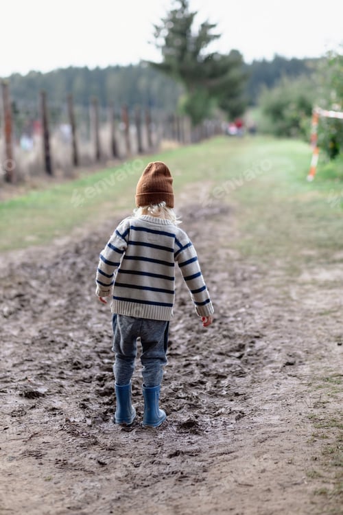 Preview: boy in rubber boots wants to step in the mud