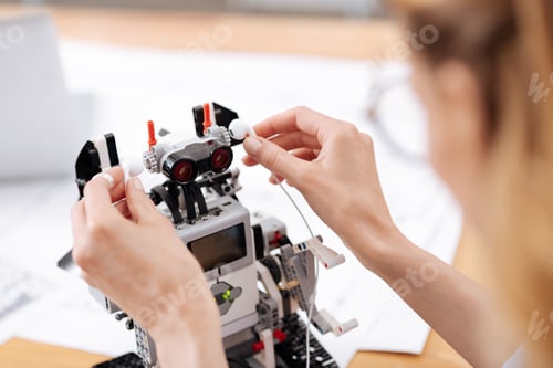 Preview: Helpful Woman Enjoying Music With Futuristic Robot Indoors