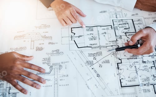 Preview: Hands of architects, engineers and building construction workers planning project with blueprint in