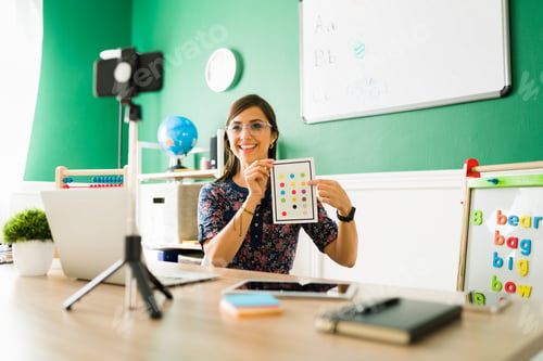 Preview: Beautiful teacher filming an online class