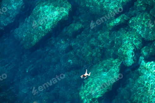 Preview: Drone view of a woman snorkeling in the sea