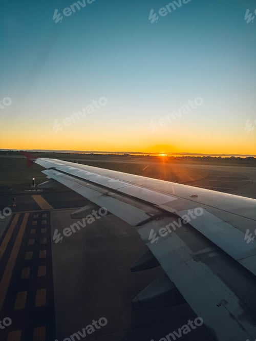 Preview: The wing of an airplane is seen in the foreground of the image