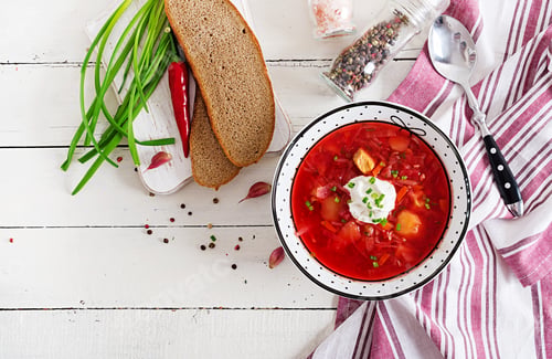 Preview: Traditional Ukrainian Russian borscht with white beans on the bowl. Beetroot soup.