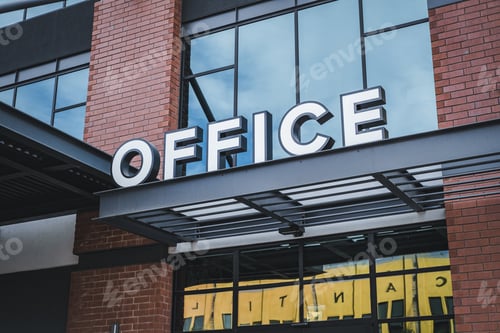 Preview: Close-up shot of a white office sign on a street of the city
