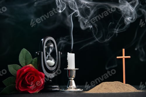 Preview: little grave with red flower and fireless candle as memory on dark surface israel death