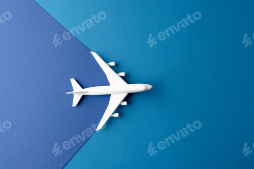 Preview: Close up of white airplane model on blue background with copy space