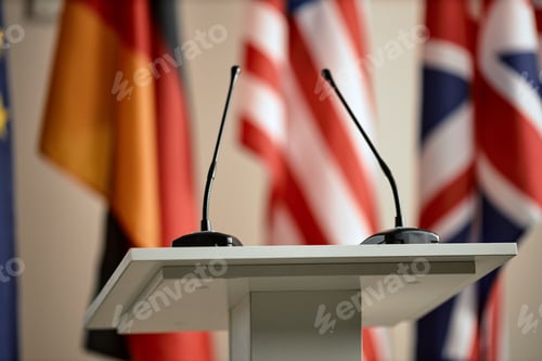 Preview: Conference Podium Positioned before International Flags Awaiting Official Address