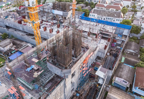 Preview: Aerial view of busy industrial construction site workers working. Development high rise building.