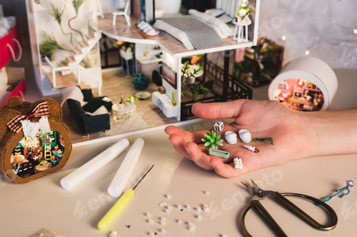Preview: Miniature home decor in a child's palm for a small house