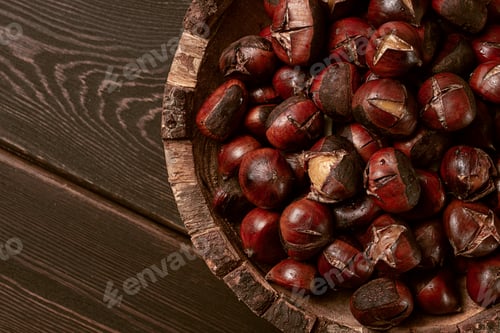 Preview: roasted chestnuts, in a wooden plate, top view, homemade, no people,