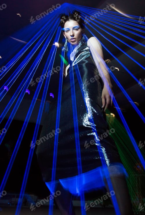 Preview: Fashion model in fashionable clothes in ultraviolet light