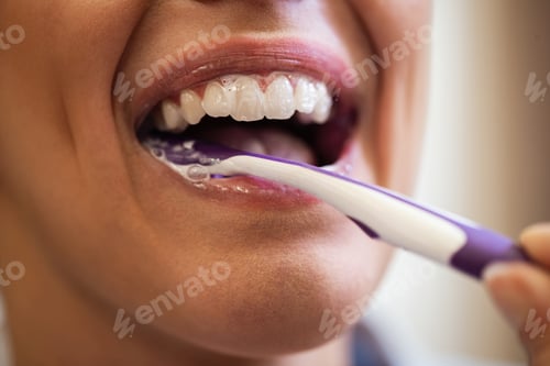Preview: Close-up of woman brushing her teeth.