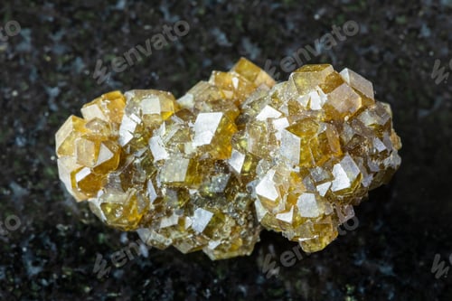 Preview: raw druse of andradite garnet crystals on black