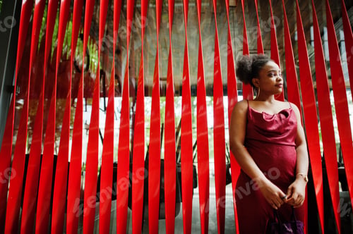 Preview: Black model in red silk dress.