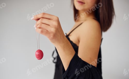 Preview: Woman in black sexy clothes shows vaginal balls and imbuilding tools in the room