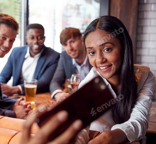 Preview: Group Of Business Colleagues Posing For Selfie In Bar After Work