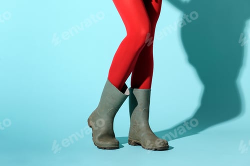 Preview: Young woman wearing a red collant and rubber gumboots