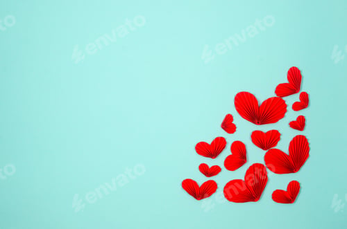 Preview: Many various red paper hearts on blue background.