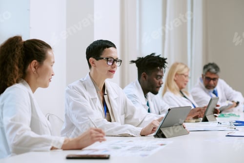 Preview: Multiethnic Group of Middle Aged Scientists Collaborating Using Digital Tablets