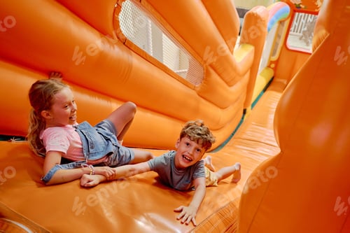 Preview: Cheerful children having fun on slide