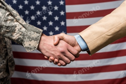 Preview: selective focus military men shaking hands near american flag