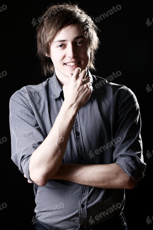 Preview: Young and attractive guy over black background