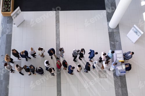 Preview: High angle view of multi-ethnic group business people standing in queue at office