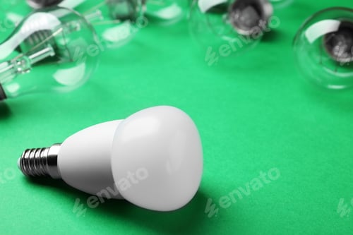 Preview: LED and incandescent lamp bulbs on green background, space for text