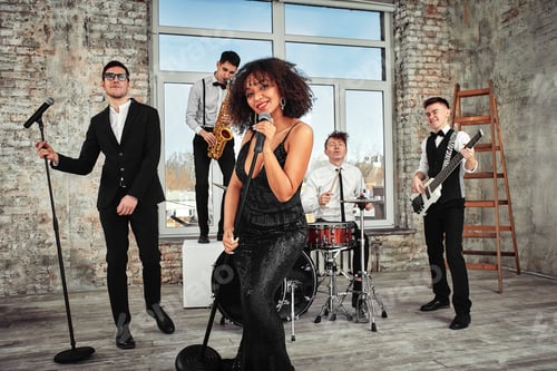 Preview: A multiracial music group performs in a recording studio. A group of international musicians