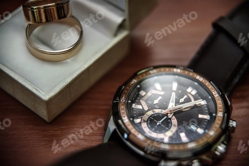 Preview: Close up of Rings and Wristwatch on Table