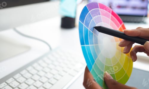 Preview: Close-up of Asian female graphic designer working with color swatch at desk in a modern office