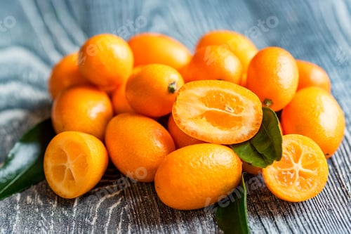 Preview: Kumquat or cumquat on wooden table