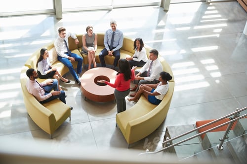 Preview: Businesswoman presenting at team meeting, elevated view