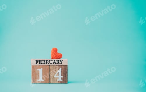 Preview: Wooden calendar show of 14th February with red heart on pastel color background.
