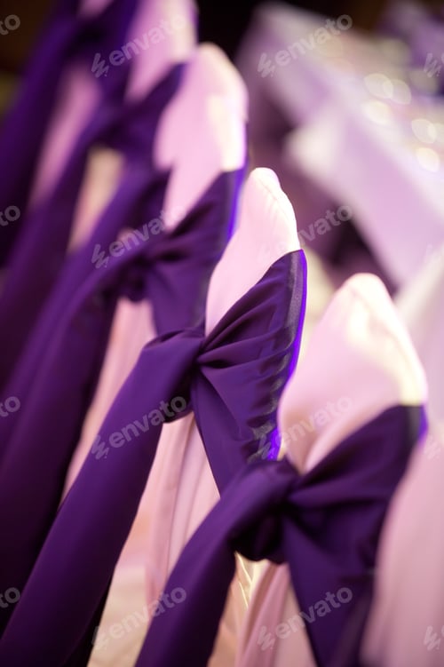 Preview: Wedding chairs with purple satin bows